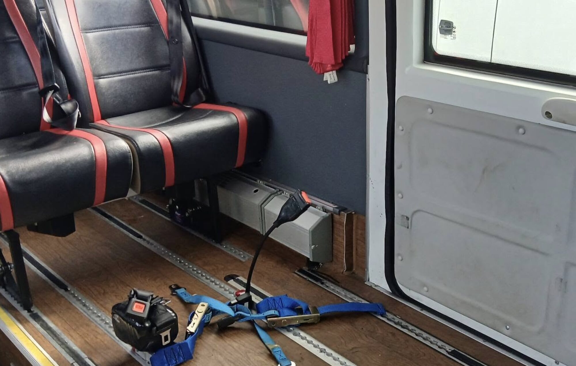 Wheelchair Accessible 3 Wheelchair tie-downs and seats in a fleet vehicle